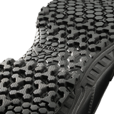 Close-up view of the black Brigade 8-inch Tactical Boots - Zip by Condor, showing a textured sole with a hexagonal tread pattern and "CONDOR" embossed in the center.