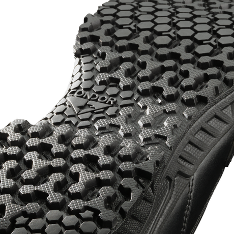 Close-up view of the black Brigade 8-inch Tactical Boots - Zip by Condor, showing a textured sole with a hexagonal tread pattern and "CONDOR" embossed in the center.
