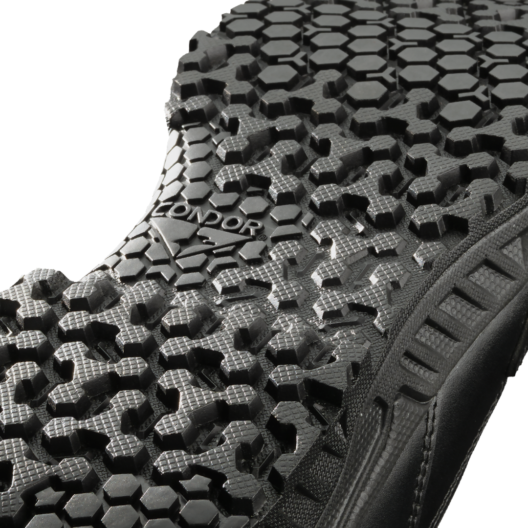 Close-up view of the black Brigade 8-inch Tactical Boots - Zip by Condor, showing a textured sole with a hexagonal tread pattern and "CONDOR" embossed in the center.