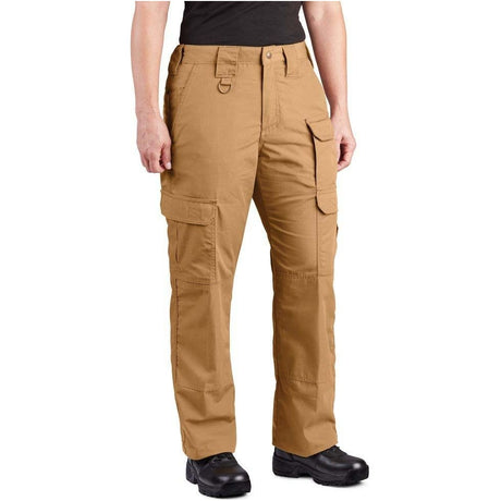 A person wearing tan cargo pants with multiple flap pockets, shown from the waist down against a plain white background.