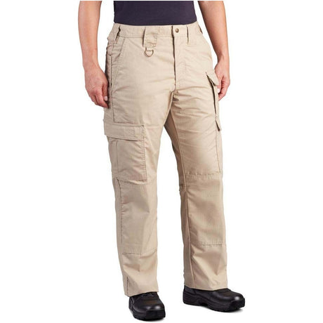 A person wearing beige cargo pants with multiple flap pockets, shown from the waist down against a plain white background.
